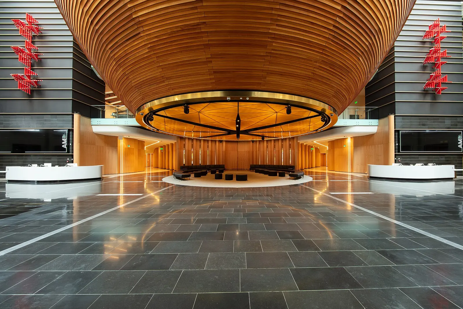 The South Atrium of Auckland Museum with the great timber Tanoa bowl overhead above a slate floor